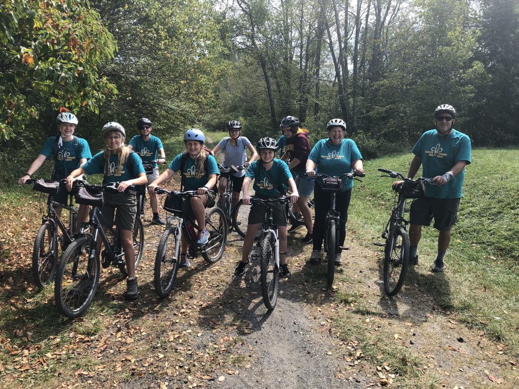 Scouts sitting on bikes.